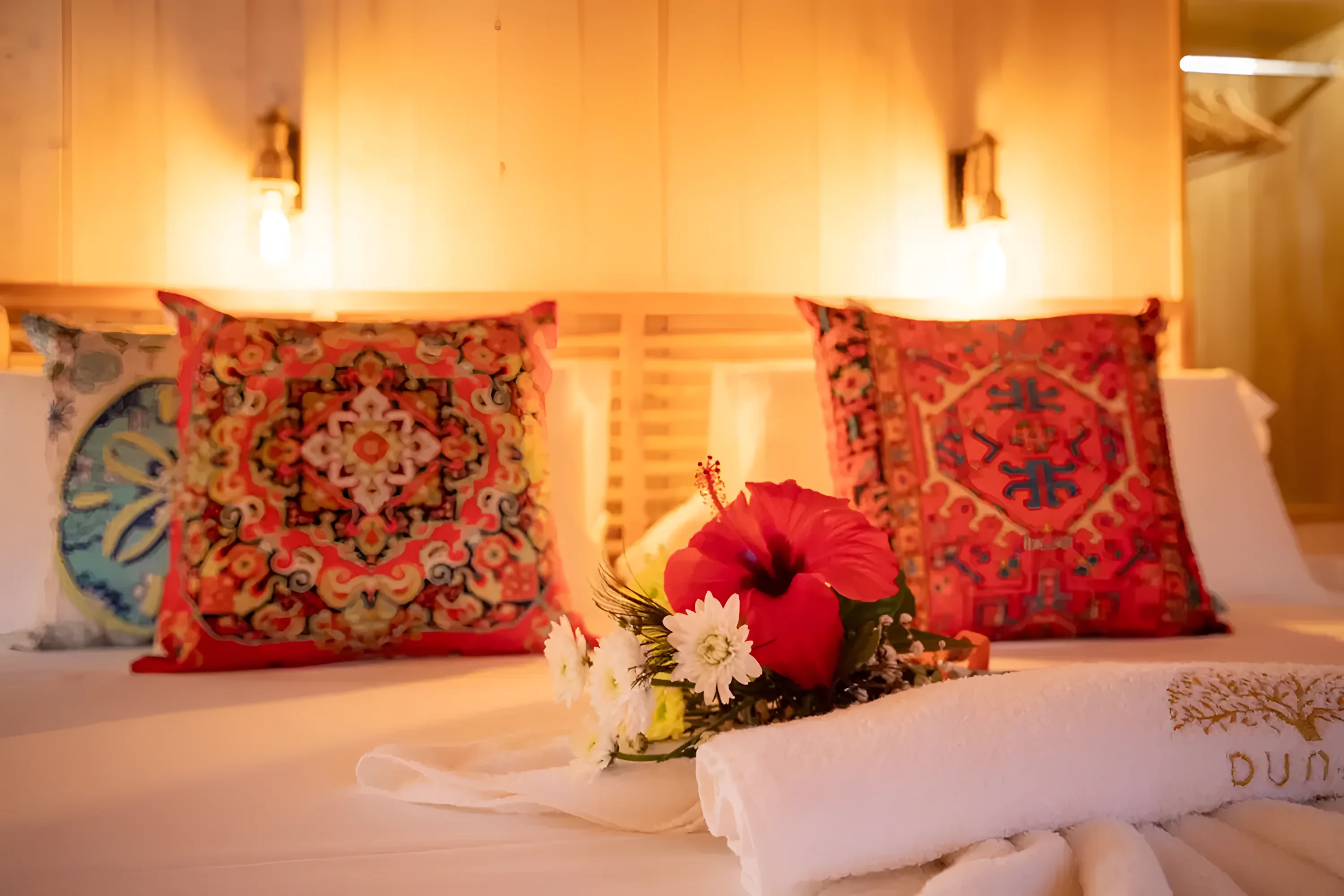 A lodge bed turned down for the night at Dunas