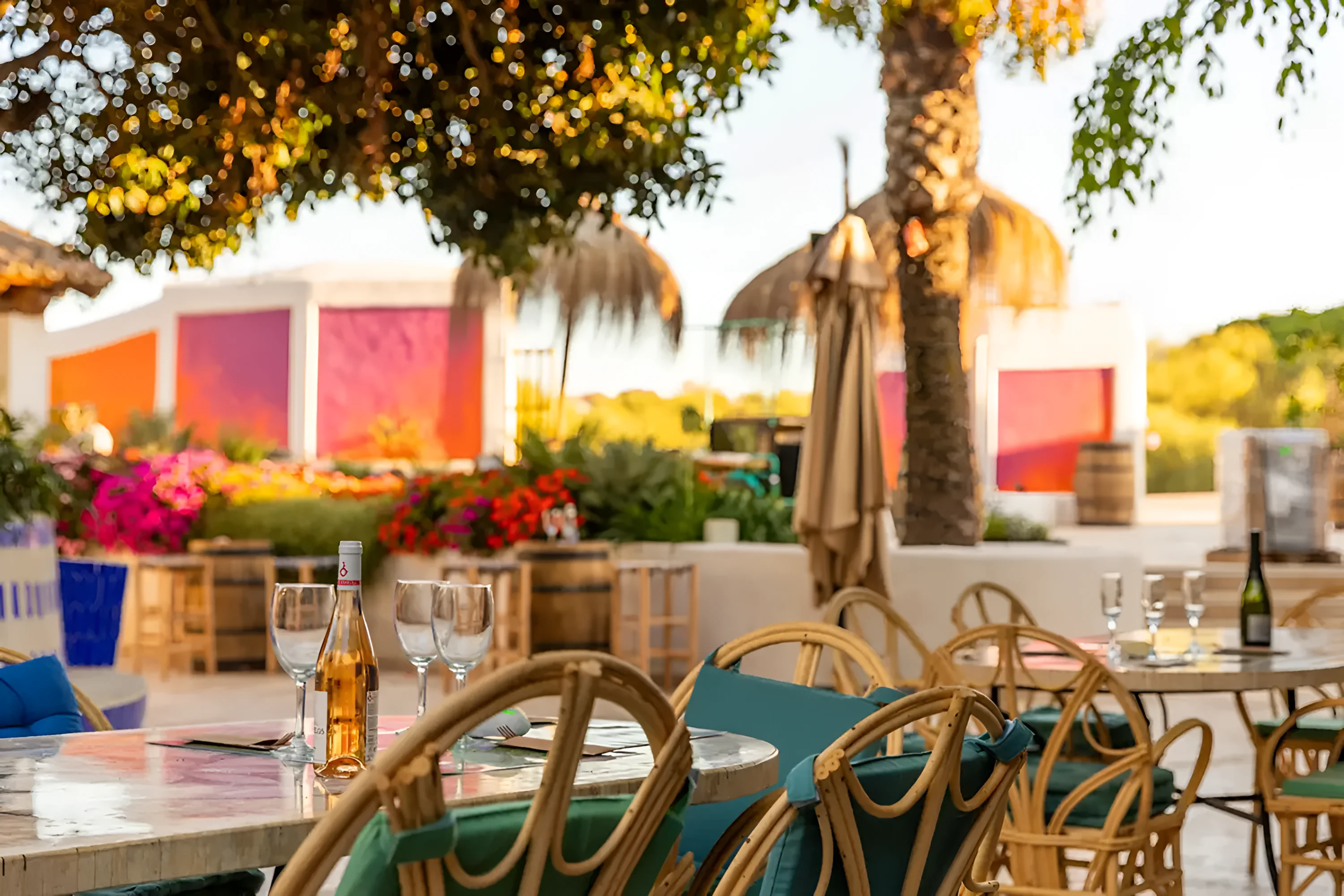 Azure Bistro's outdoor tables in the middle of the resort at midday