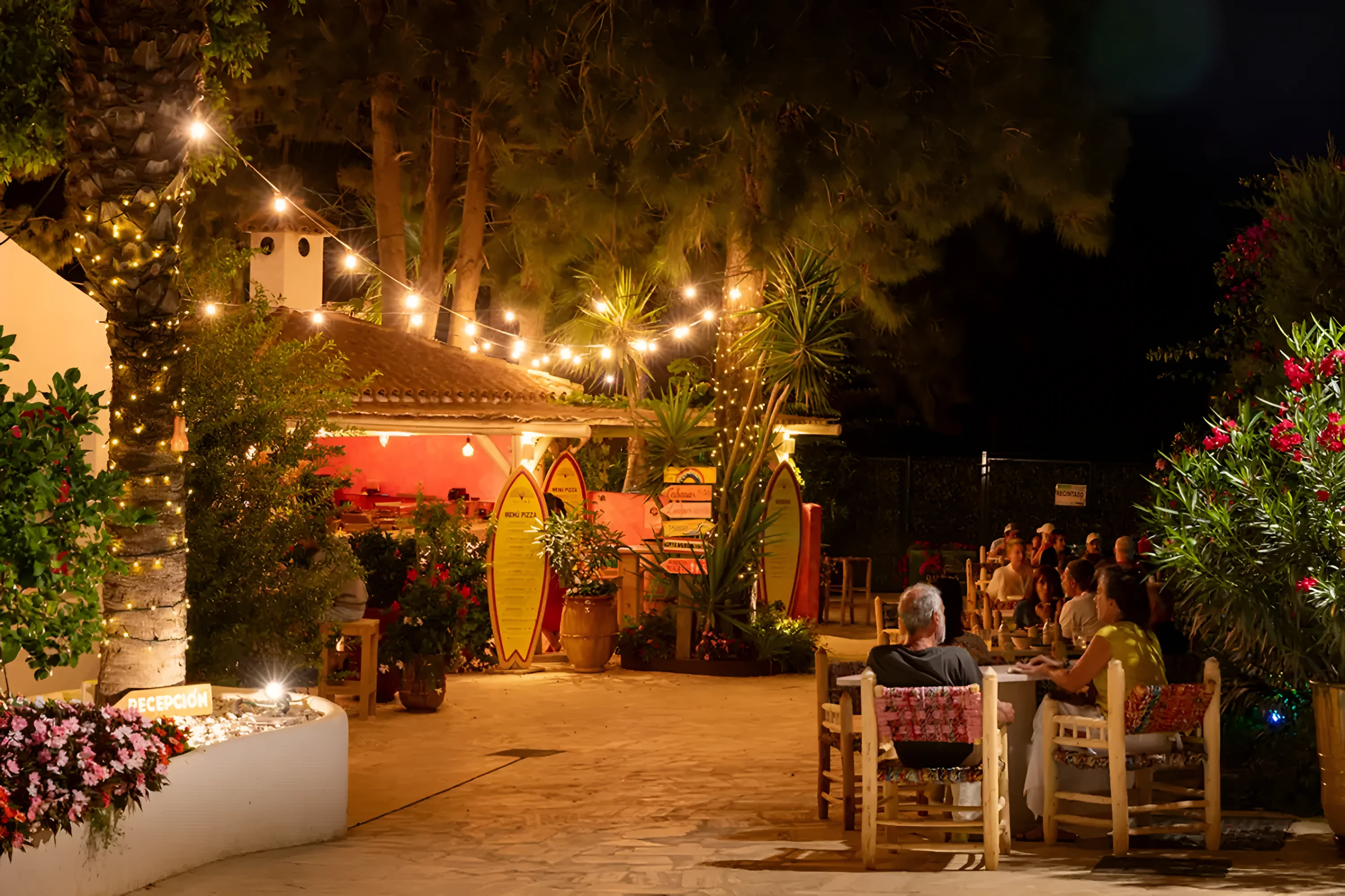 Guests eating on the terrace at Pizza a la Piazza after dark